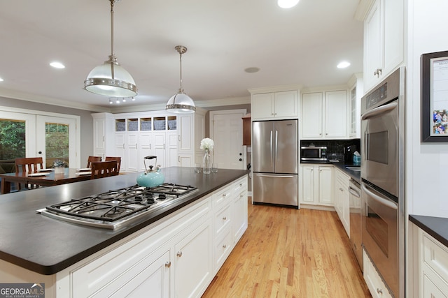 220 N Springs Ct, Sandy Springs, GA 30328 - kitchen with appliances with stainless steel finishes, dark countertops, ornamental molding, recessed lighting, and light wood-style flooring