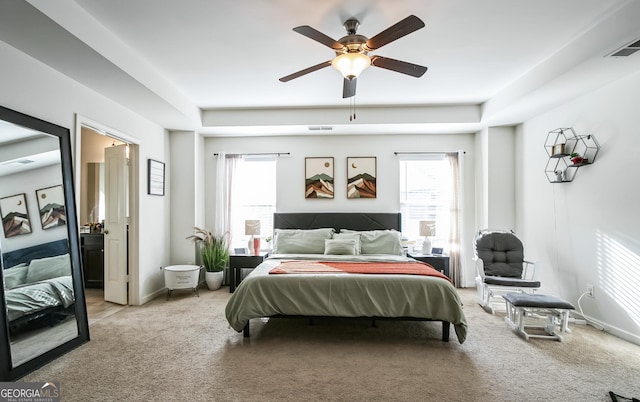 2496 Osceola Rd, Lithonia, GA 30058 - bedroom with carpet flooring, a tray ceiling, ceiling fan, and connected bathroom