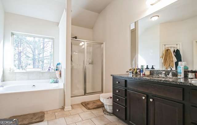 2496 Osceola Rd, Lithonia, GA 30058 - bathroom featuring a shower stall, vanity, a garden tub, tile patterned floors, and lofted ceiling