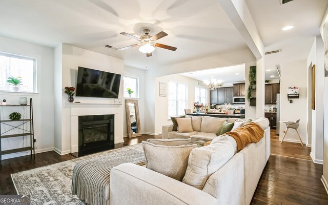 2496 Osceola Rd, Lithonia, GA 30058 - living area with a chandelier, plenty of natural light, a ceiling fan, a glass covered fireplace, and recessed lighting