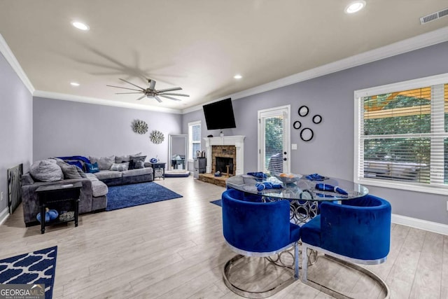 2102 Braswell Ln, Loganville, GA 30052 - living room with wood finished floors, crown molding, a stone fireplace, a ceiling fan, and recessed lighting