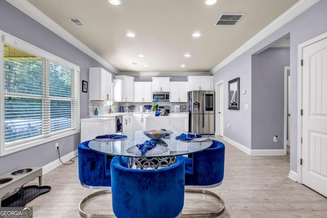 2102 Braswell Ln, Loganville, GA 30052 - dining room featuring crown molding, baseboards, light wood-type flooring, recessed lighting, and wine cooler