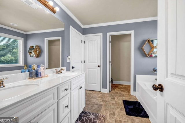 2102 Braswell Ln, Loganville, GA 30052 - full bath with double vanity, a garden tub, ornamental molding, baseboards, and stone finish floors