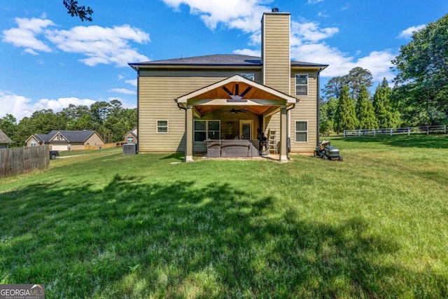 2102 Braswell Ln, Loganville, GA 30052 - rear view of house with a ceiling fan, a patio, and a chimney