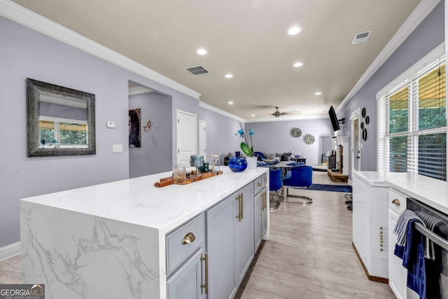 2102 Braswell Ln, Loganville, GA 30052 - kitchen with ornamental molding, open floor plan, ceiling fan, recessed lighting, and a kitchen island