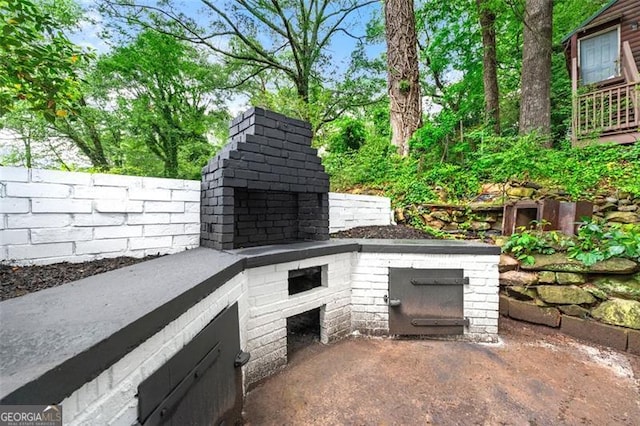 2828 Cloverhurst, Atlanta, GA 30344 - view of patio / terrace featuring fence and a fireplace