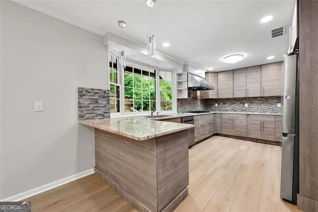 2828 Cloverhurst, Atlanta, GA 30344 - kitchen with a peninsula, appliances with stainless steel finishes, light wood-style floors, backsplash, and ornamental molding