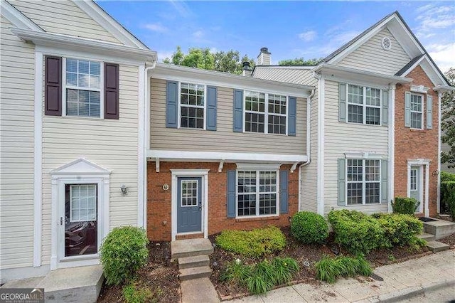 1135 Kilmington Ct, Alpharetta, GA 30009 - view of property featuring brick siding and a chimney