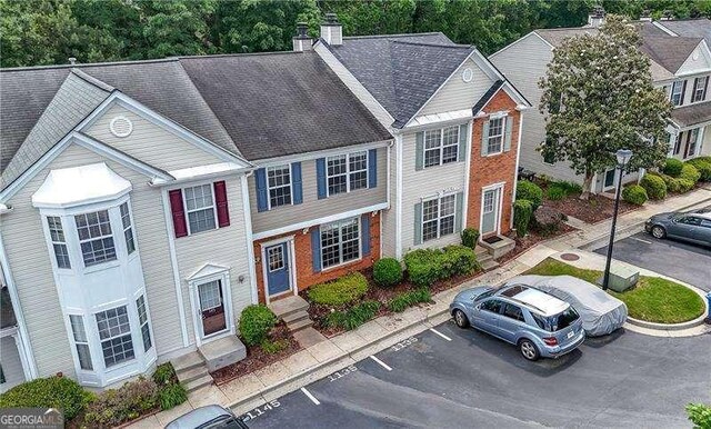 1135 Kilmington Ct, Alpharetta, GA 30009 - view of front facade with uncovered parking, entry steps, and a chimney