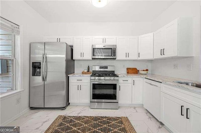 1135 Kilmington Ct, Alpharetta, GA 30009 - kitchen featuring stainless steel appliances, light marble finish floors, white cabinetry, and light stone counters