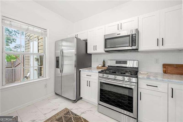 1135 Kilmington Ct, Alpharetta, GA 30009 - kitchen with stainless steel appliances, light marble finish floors, white cabinets, light stone counters, and decorative backsplash