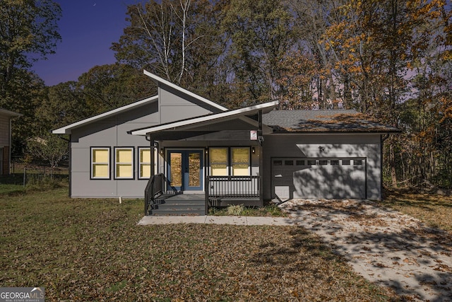 7428 Mockingbird Trl, Riverdale, GA 30274 - mid-century inspired home featuring an attached garage, driveway, a porch, and a front yard