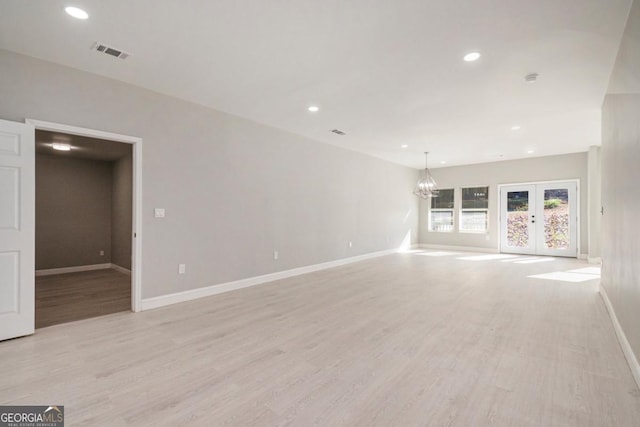 7428 Mockingbird Trl, Riverdale, GA 30274 - empty room featuring light wood finished floors, baseboards, recessed lighting, a chandelier, and french doors