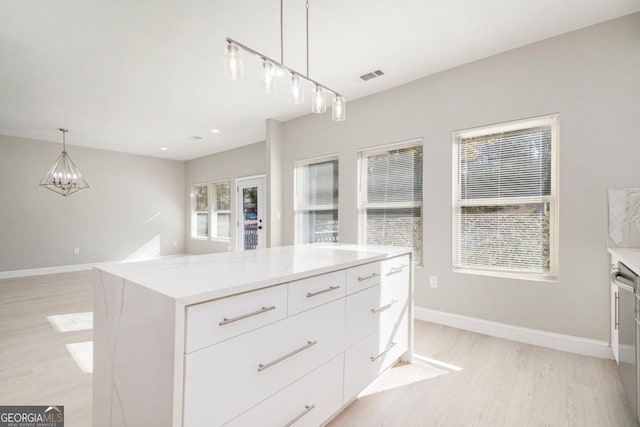 7428 Mockingbird Trl, Riverdale, GA 30274 - kitchen featuring light wood-style floors, plenty of natural light, and white cabinetry
