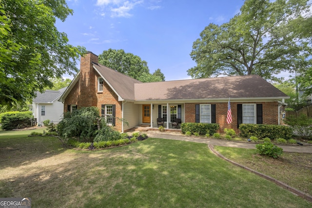 503 Bonnie Dr, Woodstock, GA 30188 - view of front of house with brick siding, a chimney, a front lawn, a porch, and a shingled roof