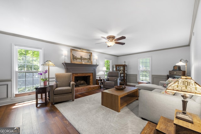 503 Bonnie Dr, Woodstock, GA 30188 - living room featuring a fireplace, dark wood-style floors, ornamental molding, healthy amount of natural light, and a ceiling fan