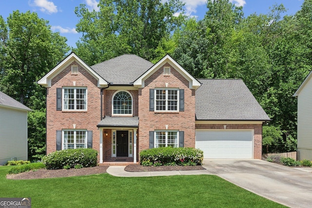 610 Golden Meadows Ln, Suwanee, GA 30024 - view of front of property with driveway, a front yard, and brick siding