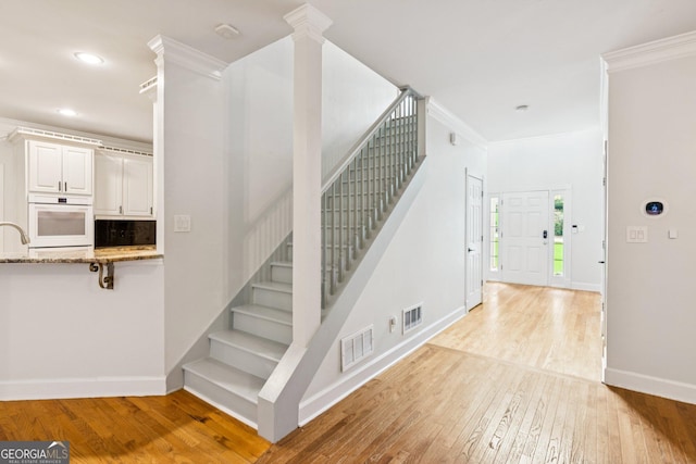 610 Golden Meadows Ln, Suwanee, GA 30024 - staircase with hardwood / wood-style floors, baseboards, recessed lighting, and crown molding