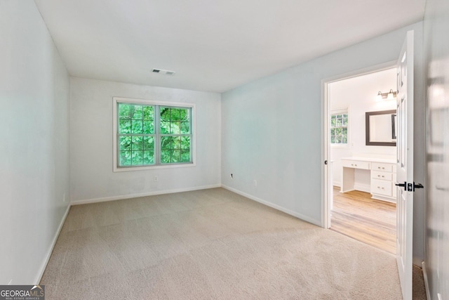 610 Golden Meadows Ln, Suwanee, GA 30024 - empty room with light colored carpet, healthy amount of natural light, and baseboards