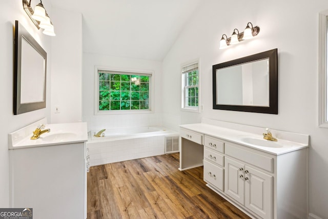 610 Golden Meadows Ln, Suwanee, GA 30024 - full bath featuring vaulted ceiling, two vanities, wood finished floors, and a bath