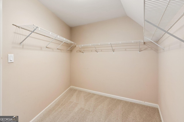 610 Golden Meadows Ln, Suwanee, GA 30024 - spacious closet featuring carpet floors and vaulted ceiling