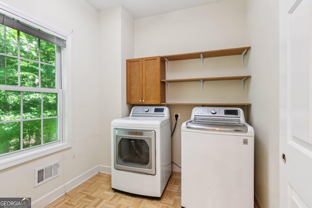 610 Golden Meadows Ln, Suwanee, GA 30024 - laundry room featuring plenty of natural light, washer and clothes dryer, cabinet space, and baseboards
