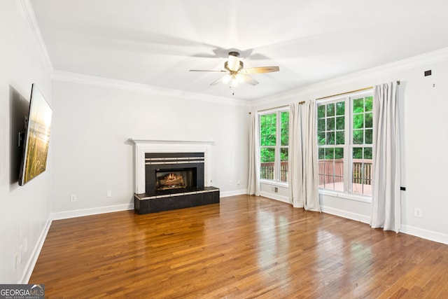 610 Golden Meadows Ln, Suwanee, GA 30024 - unfurnished living room featuring ceiling fan, wood finished floors, ornamental molding, and a lit fireplace