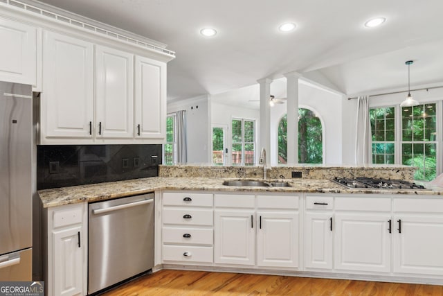 610 Golden Meadows Ln, Suwanee, GA 30024 - kitchen with appliances with stainless steel finishes, a sink, a ceiling fan, vaulted ceiling, and decorative backsplash