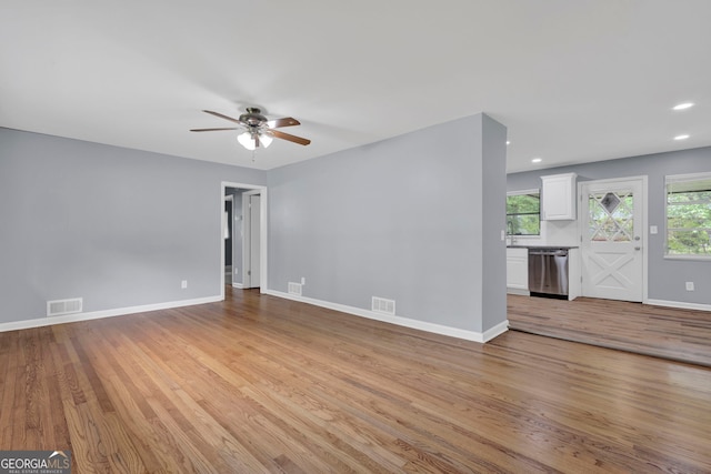 unfurnished living room featuring a ceiling fan, light wood finished floors, baseboards, and recessed lighting