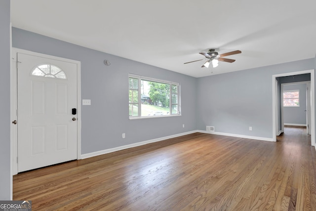 entryway with plenty of natural light, ceiling fan, wood finished floors, and baseboards