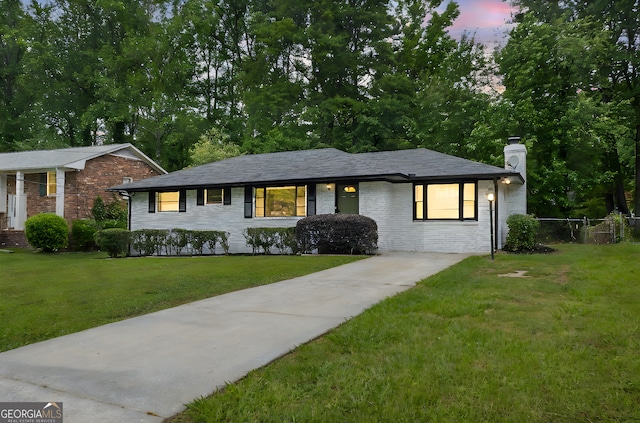 view of front facade with a chimney and concrete driveway