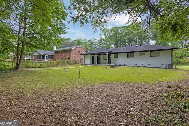 back of house featuring brick siding, central air condition unit, and crawl space