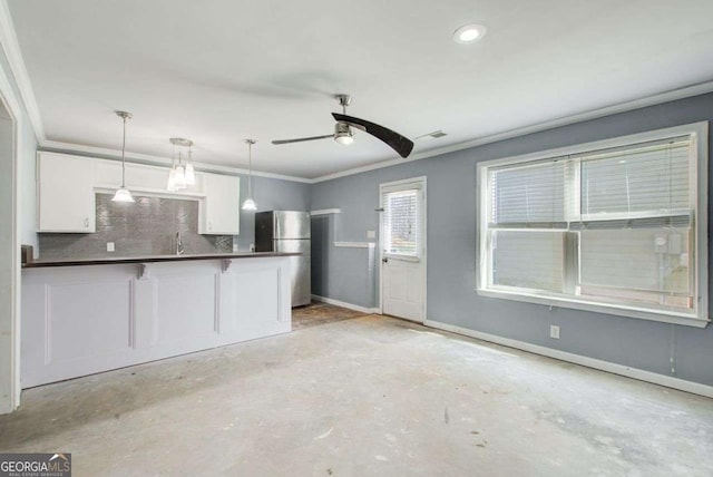 7933 Heathmore Dr, Fairburn, GA 30213 - kitchen featuring freestanding refrigerator, white cabinetry, dark countertops, decorative backsplash, and ceiling fan