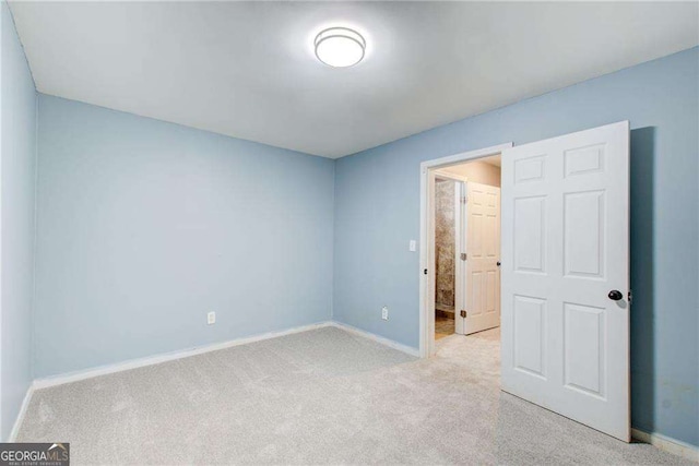 7933 Heathmore Dr, Fairburn, GA 30213 - unfurnished bedroom featuring light colored carpet and baseboards
