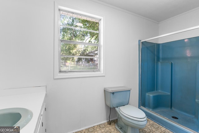full bathroom featuring a shower stall, toilet, ornamental molding, baseboards, and vanity