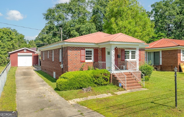 view of front of home featuring an outdoor structure, driveway, a detached garage, a front lawn, and brick siding