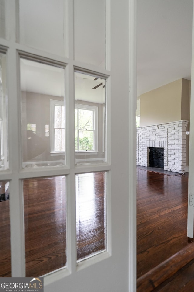 409 N Jefferson Ave, Eatonton, GA 31024 - detailed view of a brick fireplace and wood finished floors