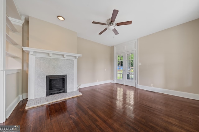 409 N Jefferson Ave, Eatonton, GA 31024 - unfurnished living room featuring wood finished floors, a ceiling fan, a tile fireplace, and baseboards