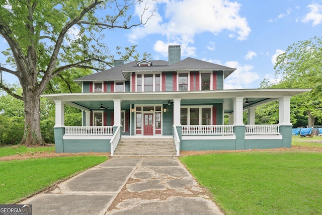 409 N Jefferson Ave, Eatonton, GA 31024 - view of front of home with a ceiling fan, covered porch, a front yard, a chimney, and roof with shingles