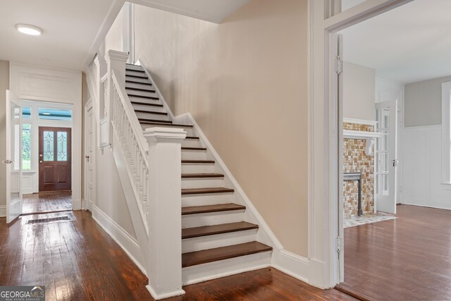 409 N Jefferson Ave, Eatonton, GA 31024 - staircase featuring wood finished floors and a decorative wall