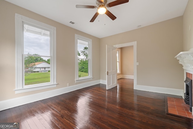409 N Jefferson Ave, Eatonton, GA 31024 - unfurnished living room with dark wood finished floors, plenty of natural light, baseboards, and a ceiling fan