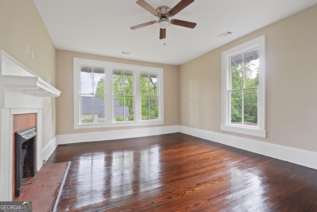 409 N Jefferson Ave, Eatonton, GA 31024 - unfurnished living room with a fireplace, healthy amount of natural light, and wood finished floors