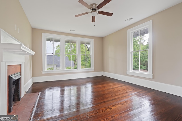 409 N Jefferson Ave, Eatonton, GA 31024 - unfurnished living room featuring a fireplace, plenty of natural light, and wood finished floors