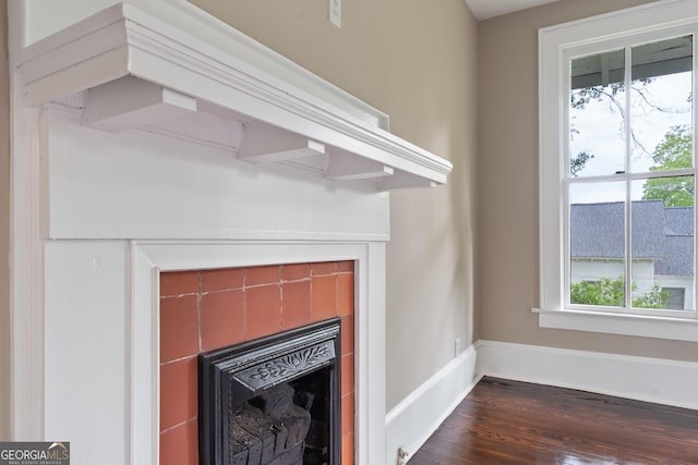 409 N Jefferson Ave, Eatonton, GA 31024 - detailed view of a fireplace, wood finished floors, and baseboards