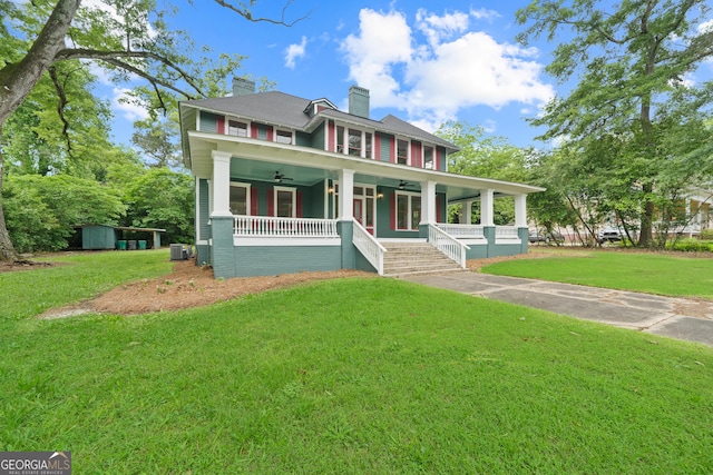 409 N Jefferson Ave, Eatonton, GA 31024 - view of front facade featuring covered porch, a ceiling fan, a chimney, a front yard, and a shed