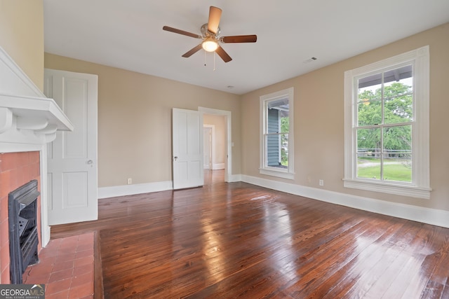 409 N Jefferson Ave, Eatonton, GA 31024 - unfurnished living room with a fireplace, hardwood / wood-style flooring, ceiling fan, and baseboards