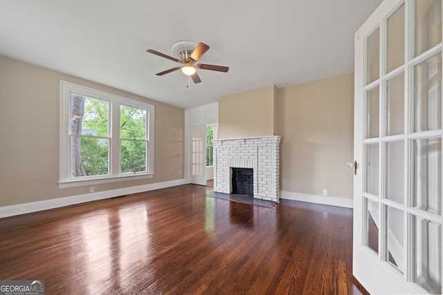 409 N Jefferson Ave, Eatonton, GA 31024 - unfurnished living room with a ceiling fan, wood finished floors, and a fireplace