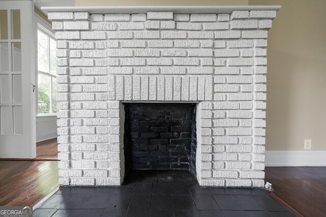 409 N Jefferson Ave, Eatonton, GA 31024 - detailed view of baseboards, a fireplace, and wood finished floors