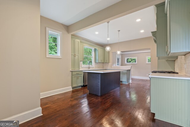 409 N Jefferson Ave, Eatonton, GA 31024 - kitchen featuring green cabinets, a center island, baseboards, light countertops, and tasteful backsplash