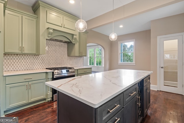 409 N Jefferson Ave, Eatonton, GA 31024 - kitchen with stainless steel gas stove, green cabinets, custom range hood, dark wood-style floors, and decorative backsplash